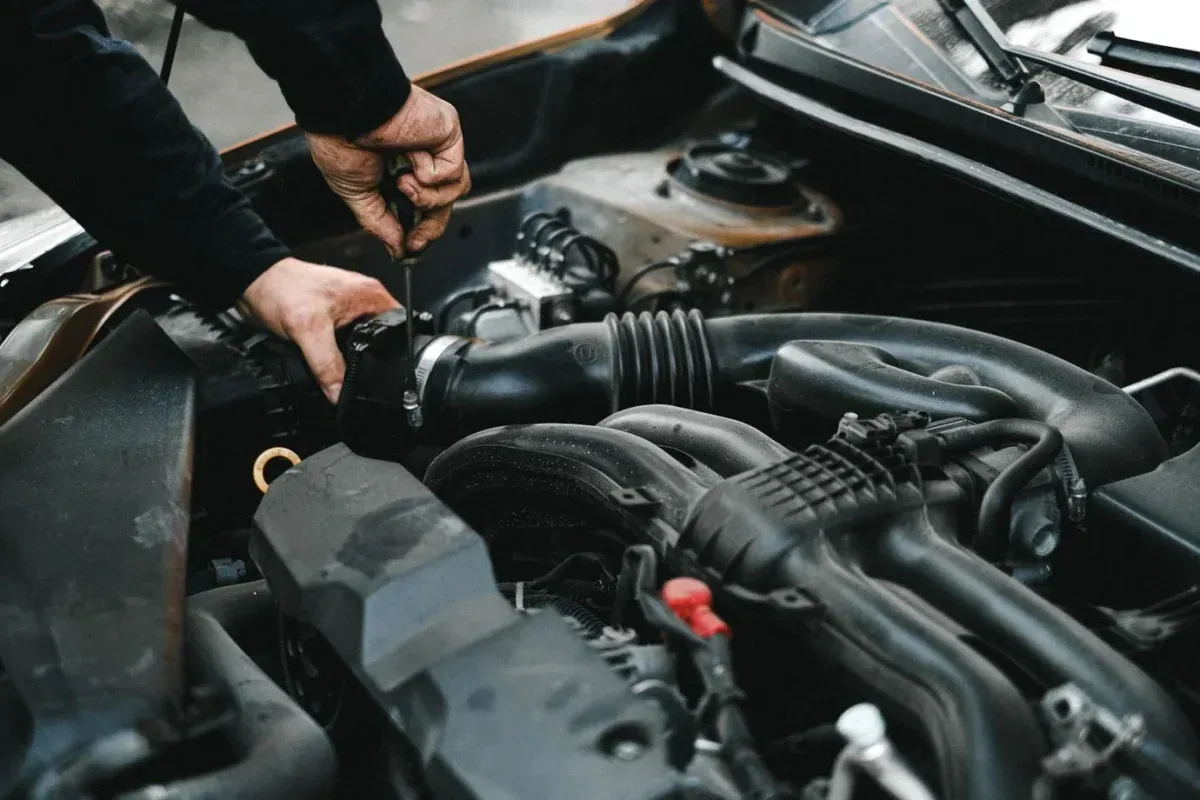 Illustrative stock photograph: Mechanic inspecting an engine bay